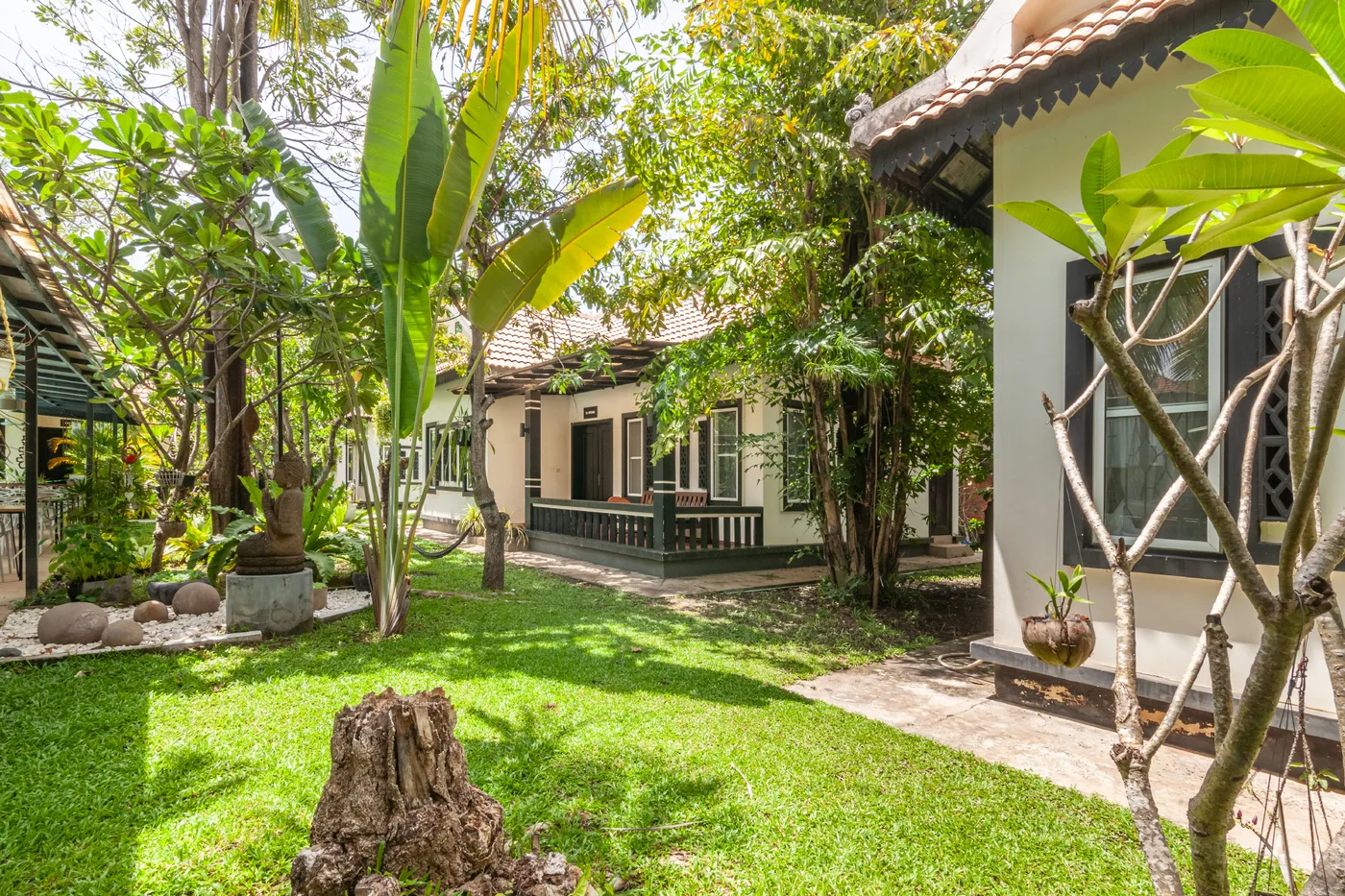 Several Banana Resort villas opening onto the shared tropical garden
