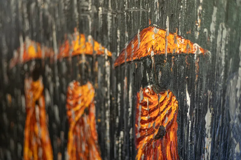 Cambodian monk painting on the wall