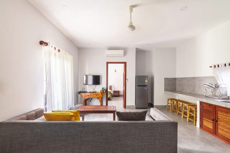 Villa living room — sofa, art and open kitchen