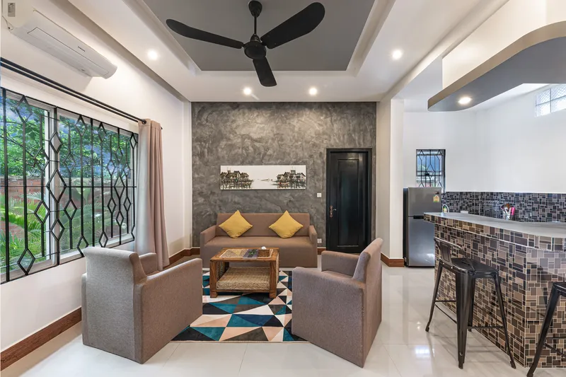 Villa living room — sofa, art and open kitchen